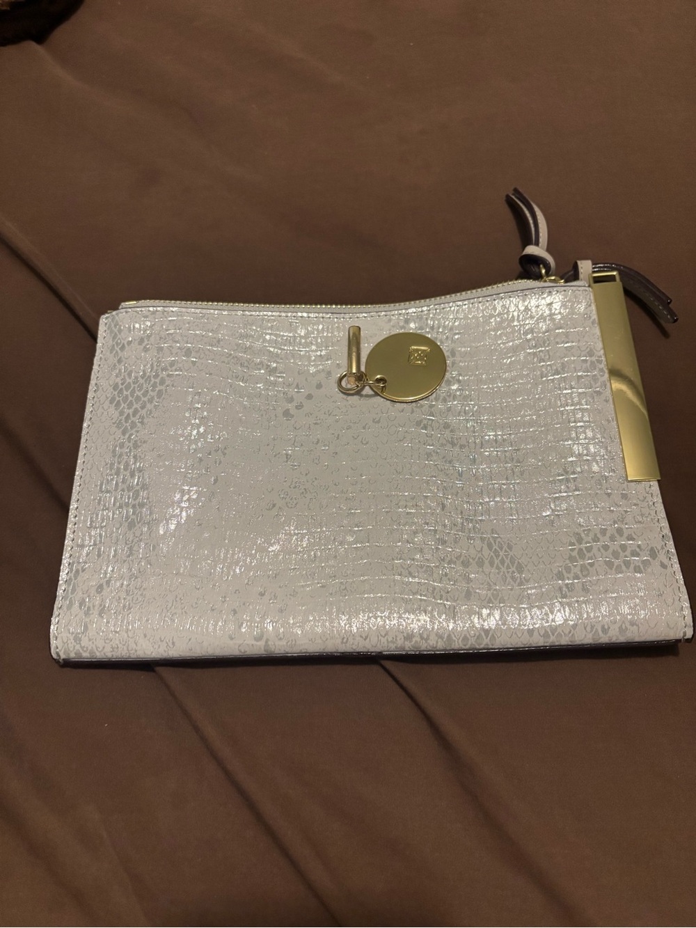 Elegant White Embossed Zip Wristlet with Gold Charm